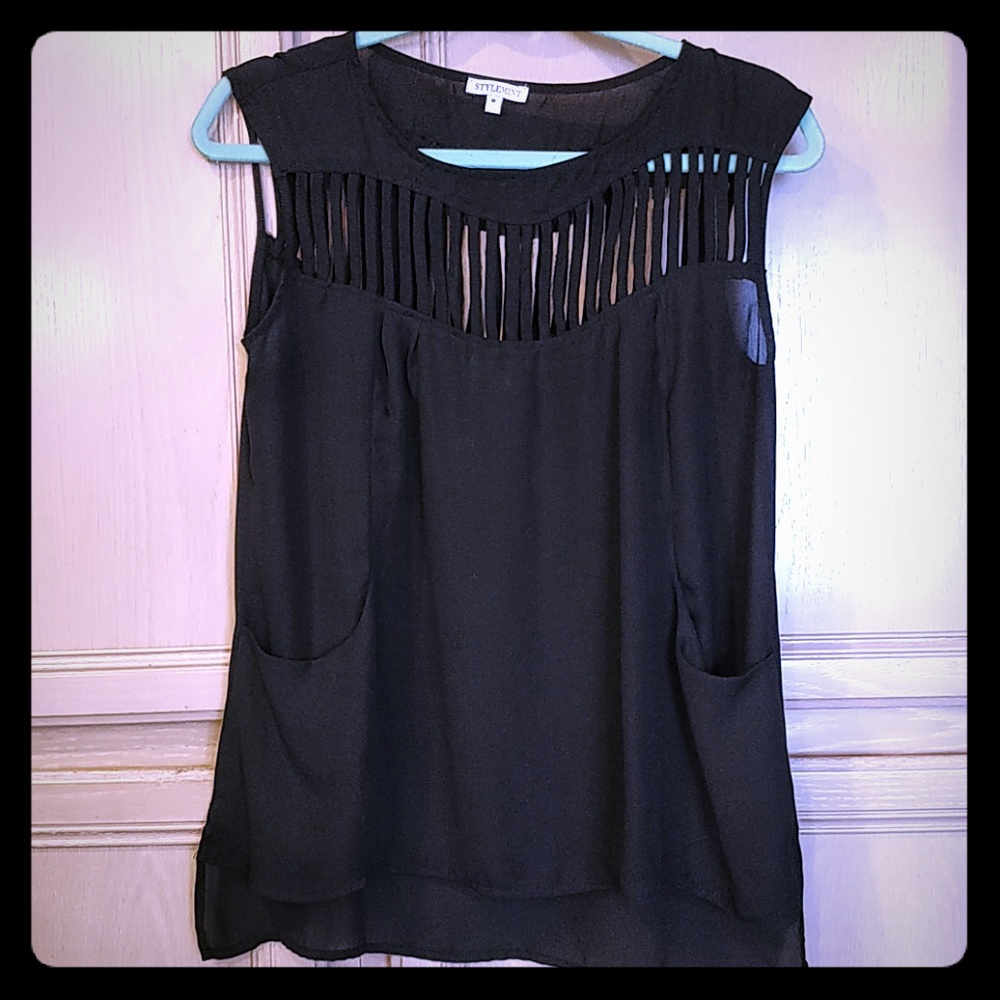 Sheer black top with vertical cut outs and pockets